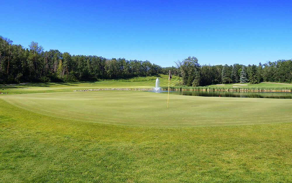 The signature hoInnisfail Golf Club - Course Layout - Hazelwood 6le of the Innisfail Golf Club was completely redesigned beginning in the fall of 2017. Opening mid-summer of 2018, the redesign has been extremely well received. The elevated tee shot requires remains, however, there is far more room then before – allowing the more flexibility for options off the tee. Ideally, a tee shot of approximately a 240 yard shot will position you properly for the approach. Hazelwood Lake is on the left and dense bush still guards the right side from the tee. The approach shot is still one of the most difficult on the course. The green has been expanded in size, but has become even closer to an island green than before. Large bunkers guard short, right and long of this green that, in classic Innisfail-style in undulating and hard to read. Pay close attention here, high scores are still in play.